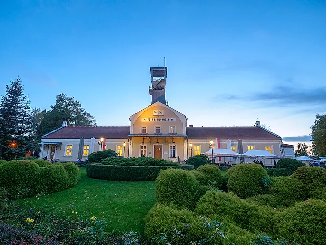 The Daniłowicz Shaft building and its headframe at dusk, the starting point of the tour